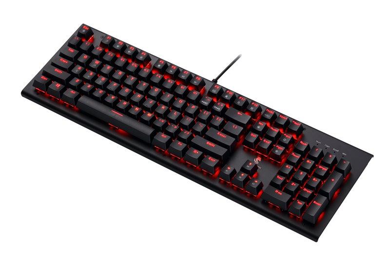 Op de afbeelding: Een zwart computertoetsenbord met een volledige QWERTY-indeling en een numeriek toetsenblok. De toetsen zijn verlicht met een felrood licht en een dunne zwarte kabel steekt uit de rechterbovenhoek van het rechthoekige apparaatframe.