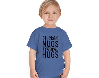 May include: A young child wearing a blue t-shirt with the text "Chicken Nugs & mama HUGS" printed in black.