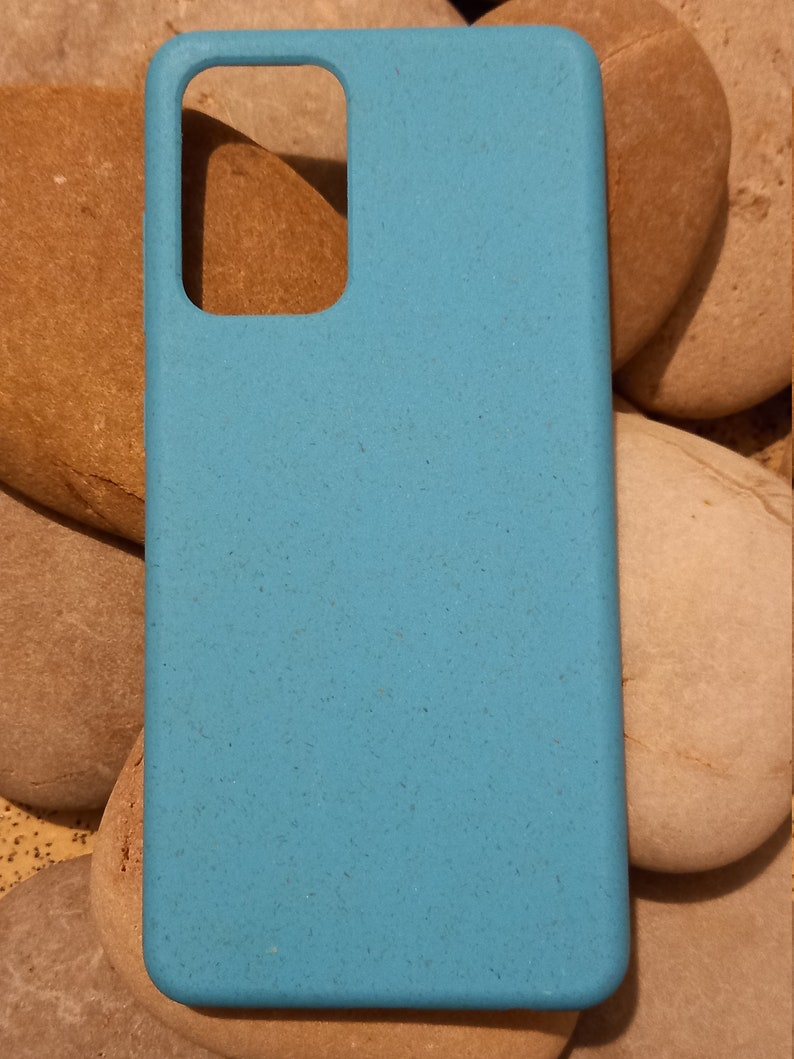 A turquoise case sitting on pebbles