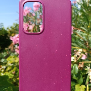 A cherry red case set amidst nature