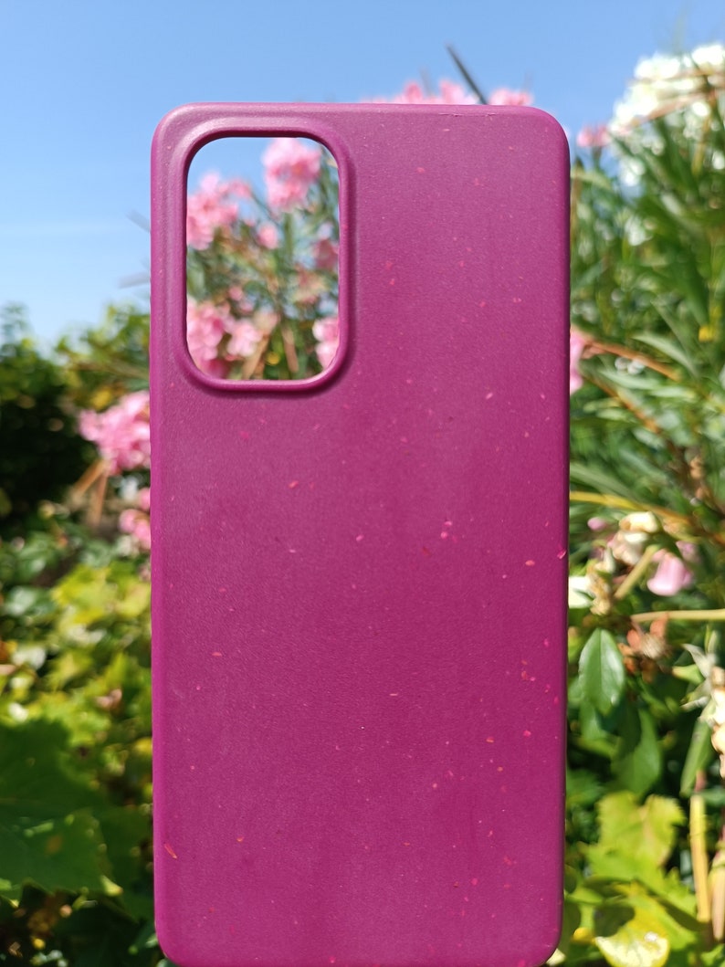 A cherry red case set amidst nature