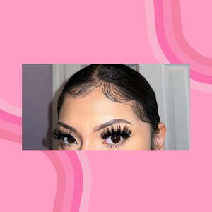 May include: Close-up of a person's face with long, dark eyelashes. The person has dark hair pulled back from their face.