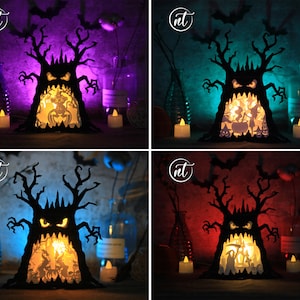 May include: A black papercraft Halloween tree with a scary face and a glowing orange interior. The tree is illuminated with a warm white light and is surrounded by decorative elements, including a bottle, a candle, and a small wooden sign.