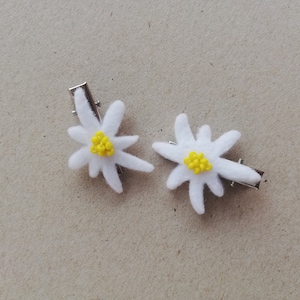 Pair of handmade Edelweiss hair pins made of cutout felt and sewn on yellow beads. Hair embellishments you can use on both sides of the head