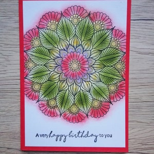 Biglietto di auguri mandala fatto a mano. Un buon compleanno per te. Sfondo stampato e colorato. Puntini d'oro. Rosso e verde. Busta inclusa