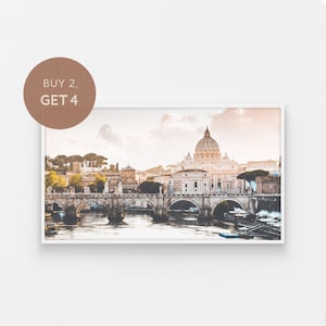 May include: A panoramic view of the city of Rome, Italy, with the iconic dome of St. Peter's Basilica in the background. The River Tiber flows through the city, with a bridge in the foreground. The sky is a soft, pastel pink and orange.