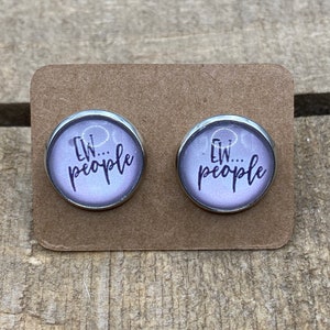 May include: A pair of silver stud earrings with a purple background and the text "Ew...people" in black.
