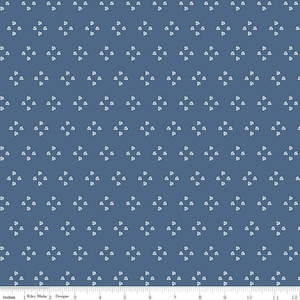 May include: A blue fabric with a repeating pattern of white three-leaf clover shapes.
