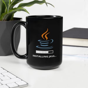 May include: Black ceramic mug with a white graphic of the Java logo and the text "INSTALLING JAVA..." printed on it.