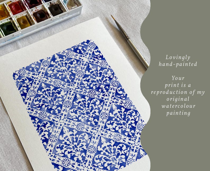 May include: A white sheet of paper featuring a blue watercolor painting with a repeating diamond and floral pattern. A paintbrush and a watercolor paint set are visible. The text reads: Lovingly hand-painted. Your print is a reproduction of my original watercolour painting.