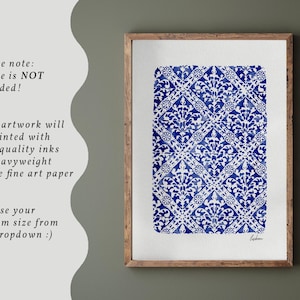 May include: A rectangular art print featuring a blue and white repeating damask pattern on a white background, enclosed in a wooden frame. The print displays a detailed floral motif arranged in a diamond grid, with the word Lisbon written in script.