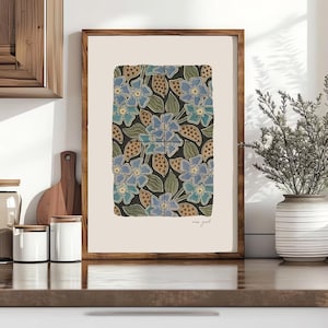 May include: A framed art print featuring a floral pattern. The design showcases blue flowers, green leaves, and brown accents on a dark background. The words "new york" are written in the bottom right corner.