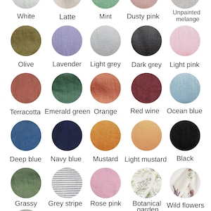 May include: A linen napkin color chart featuring twenty-six circular fabric swatches in various solid colors and patterns, including white, latte, mint, dusty pink, unpainted melange, olive, lavender, light grey, dark grey, light pink, terracotta, emerald green, orange, red wine, ocean blue, deep blue, navy blue, mustard, light mustard, black, grassy, grey stripe, rose pink, botanical garden, wild flowers, and natural undyed.