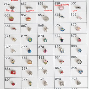 May include: A grid of 100 small silver charms with various designs, including hearts, flowers, animals, and words. The charms are numbered from 851 to 900.
