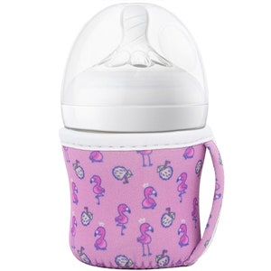 May include: A pink and white insulated bottle holder with a flamingo and apple print. The holder has a handle and fits a standard baby bottle.