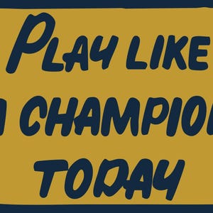 May include: A rectangular sign with a dark blue border and a mustard yellow center. The text "PLAY LIKE A CHAMPION TODAY" is written in dark blue, stylized, uppercase letters.