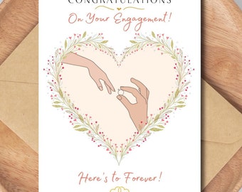 Könnte beinhalten: Eine weiße Karte mit einem herzförmigen floralen Kranz und zwei Händen, die einen Ring halten. Der Text lautet "Herzlichen Glückwunsch zu Ihrer Verlobung! Auf ewig!"