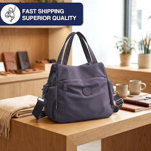 May include: A dark purple tote bag with a shoulder strap and top handles. The bag has multiple pockets and a circular logo on the front. The text "FAST SHIPPING SUPERIOR QUALITY" is in a blue rectangle in the upper left corner.