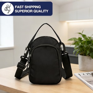 May include: Black crossbody bag with a small front pocket, adjustable shoulder strap, and a top handle. The bag has a zipper closure and a clip for attaching the strap. The text "FAST SHIPPING SUPERIOR QUALITY" is in a blue rectangle.