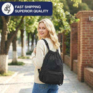 May include: A black drawstring backpack with a front pocket and adjustable straps. The backpack is being worn by a person. The image also contains the text "FAST SHIPPING SUPERIOR QUALITY" in a blue rectangle.