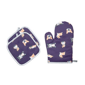 May include: A set of two purple oven mitts and two purple pot holders with a white trim. The mitts and pot holders feature a repeating pattern of cartoon corgis.