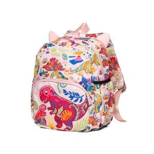 May include: A pink backpack with a dinosaur print. The backpack has two small ears on the top and a large pocket on the front with a colorful dinosaur design.