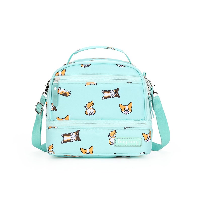 May include: A turquoise blue lunch bag with a double zipper closure and an adjustable shoulder strap. The bag features a repeating pattern of cartoon corgis and the text "Bagitory".