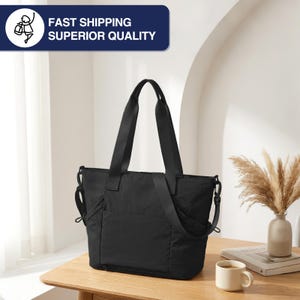 May include: A black tote bag with long shoulder straps and a detachable crossbody strap. The bag has a rectangular shape with a pocket on the front. The text "FAST SHIPPING SUPERIOR QUALITY" is in a blue rectangle in the upper left corner.