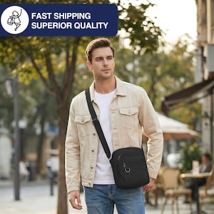May include: A black crossbody bag with multiple zippered compartments and a silver-colored ring on the front. The bag is worn over the shoulder with a black strap. The person is wearing a light tan jacket, white t-shirt, and blue jeans.