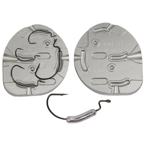 May include: Two silver metal moulds for making fishing lures. The mould on the left has three hooks in it. The mould on the right has three empty spaces for the lure. The text on the mould on the right says "VMC 7316 1/0-5/0 F186".