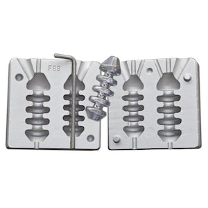 May include: A silver-colored fishing lure mold with a matching lure and a metal tool. The mold is made of two pieces and has the text "F88" on one side. The lure has a unique, segmented design.