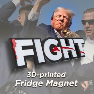 May include: A 3D-printed fridge magnet with the word "FIGHT" in white letters with red paint splatters. The magnet is in front of a blurred image of a man with a red mark on his face.