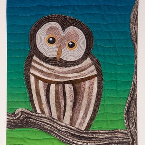 May include: A brown and white owl with yellow eyes perched on a branch against a blue and green gradient background.