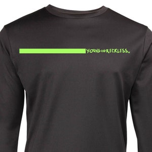 May include: Black long-sleeve shirt with a green stripe across the chest and a green stripe down the right sleeve. The text "YOUNG AND RECKLESS" is printed in green on the shirt.