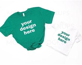 May include: Two t-shirts, one teal green and one white, both with the text "your design here" printed on the front.