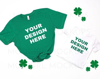 May include: Two blank t-shirts, one green and one white, with the text "YOUR DESIGN HERE" on each. The shirts are laid out on a white surface with green four-leaf clovers scattered around them.