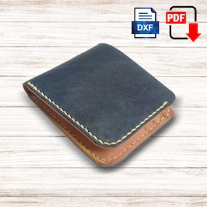 May include: A handcrafted bi-fold wallet with a navy blue exterior and a tan interior. The edges are stitched with a light-colored thread. The wallet is made of leather and has a classic design. The image also includes DXF and PDF icons.