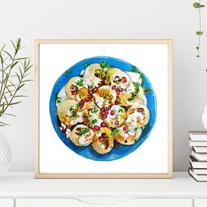 May include: A watercolor painting of a blue plate with a colorful Indian street food dish called "pani puri". The dish is made with puffed bread, potatoes, chickpeas, yogurt, and spices.