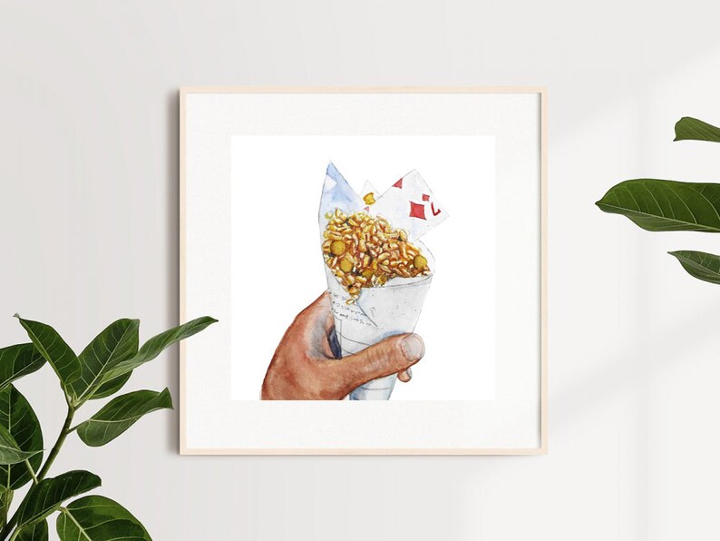 May include: A hand holds a white paper cone filled with a mixture of rice, chickpeas, and other ingredients. The cone is topped with a red and white card.