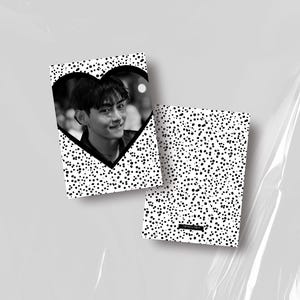 May include: Two black and white notebooks. One notebook features a heart-shaped cutout with a grayscale photo of a person. The other notebook has a pattern of black dots on a white background.