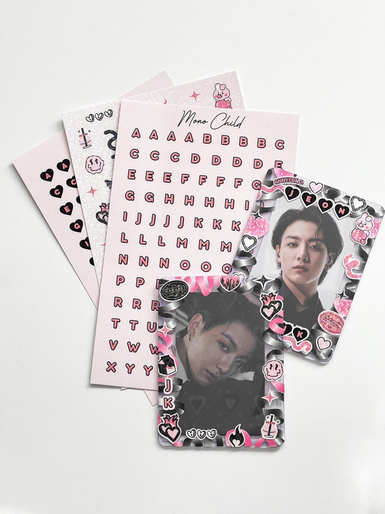 May include: A collection of pink and black stickers and photo cards. The stickers include hearts, letters, and other graphics. The photo cards feature a person in decorative frames. The text "Mono Child" is visible.