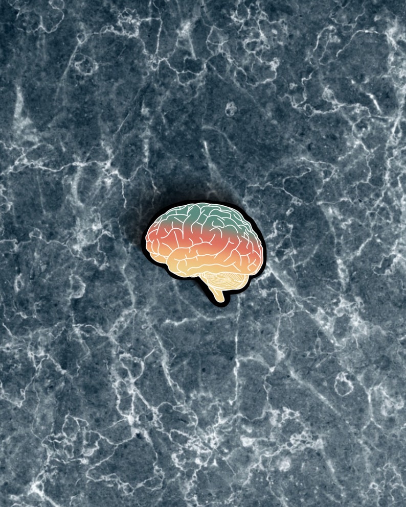 May include: A colorful brain-shaped pin with a gradient of green, orange, and yellow. The pin is outlined in white and has a black backing.