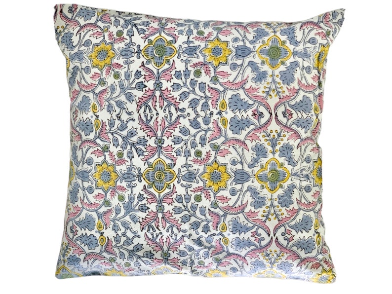 May include: A white pillow cover with a floral pattern in shades of pink, blue, and yellow. The pattern features intricate designs of leaves and flowers.