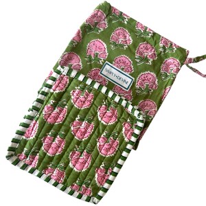 May include: A set of two green and pink floral quilted hot pads with white and green striped trim. The hot pads are packaged in a matching green and pink floral drawstring bag with a white label that reads "Simply Devine".