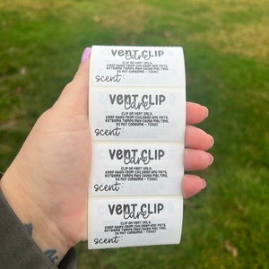 May include: Four white labels with black text that reads "Vent Clip Care" and instructions for use. The labels are for car air fresheners and include the text "Clip on vent only. Keep away from children and pets. Extreme temps may cause melting. Do not consume - Toxic! Scent:"