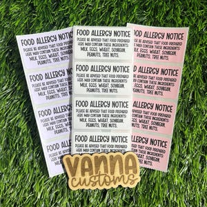 May include: Nine food allergy notice stickers with pink and white backgrounds. The stickers have black text that reads "Food Allergy Notice" and "Please be advised that food prepared here may contain these ingredients: Milk, Eggs, Wheat, Soybean, Peanuts, Tree Nuts."