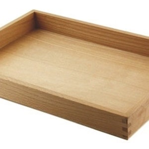 May include: A natural wood tray with a rectangular shape and a small handle on one side.