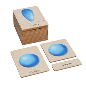 May include: A set of wooden educational cards featuring illustrations of geometric shapes, including a sphere and an ovoid. The cards have the names of the shapes printed on them: "sphere" and "ovoid".