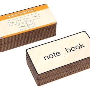 May include: Compound Matching Puzzle with wooden tiles featuring words like "bath tub", "snow man", "bed room", and "note book".