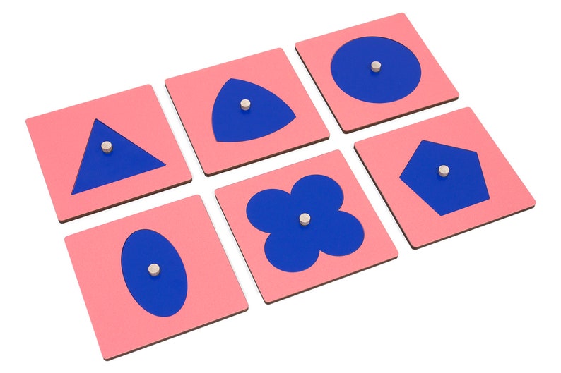 May include: Six pink square wooden tiles with blue shapes cut out. The shapes are a circle, triangle, oval, pentagon, flower, and a teardrop shape.